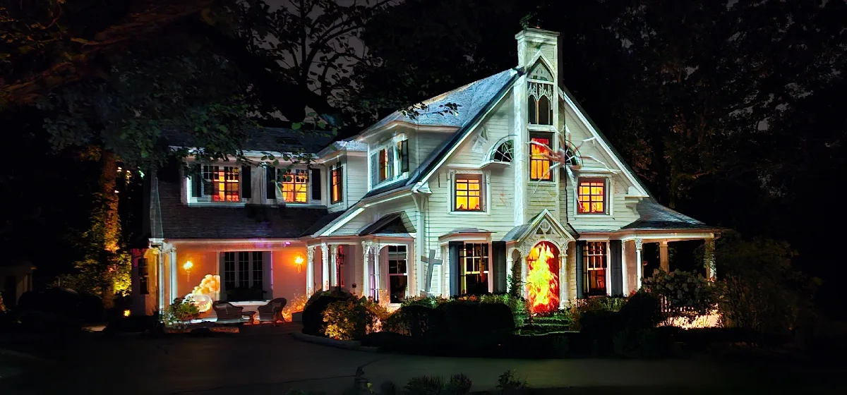 A home's facade projection-mapped with a Halloween scene